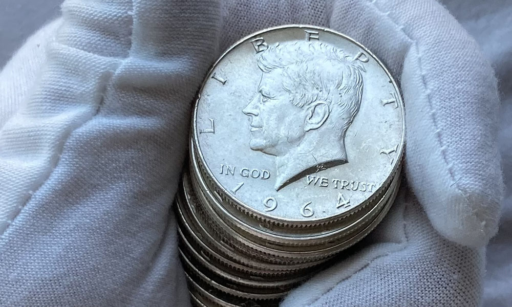 1964 kennedy half dollars held in hand pimbex