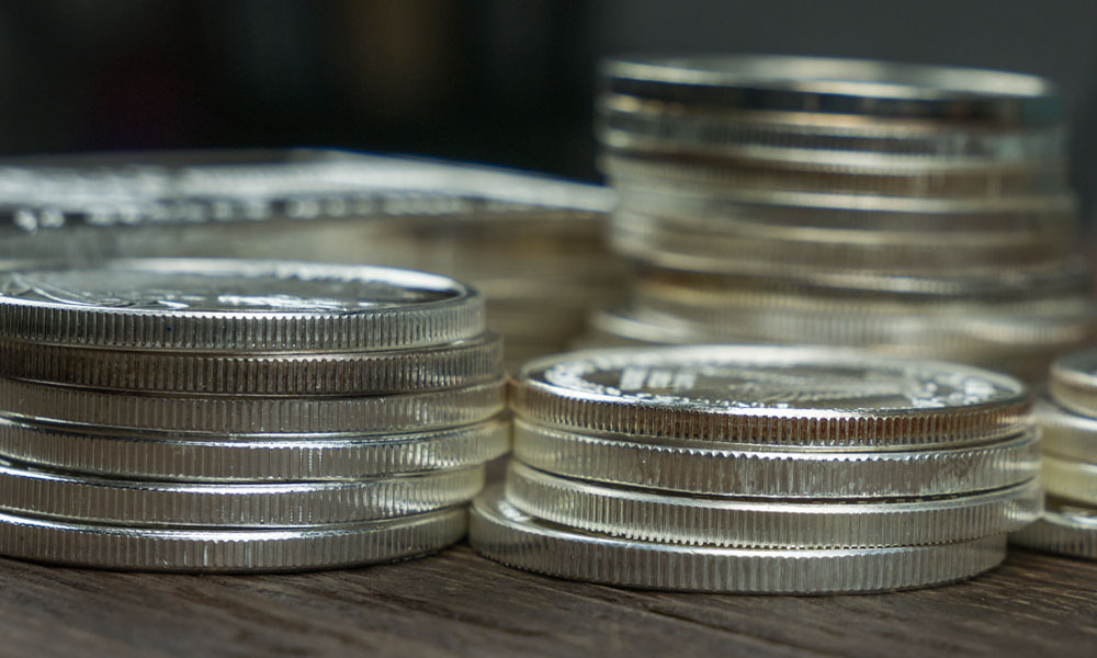 silver stack bullion coins on table pimbex